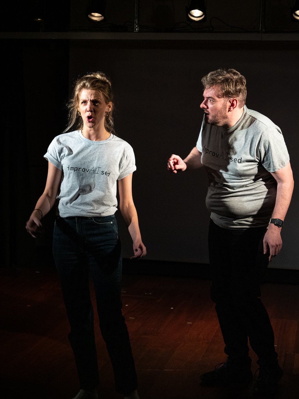 Emily Matthews and Tom Gilder on stage in ImprovAIsed